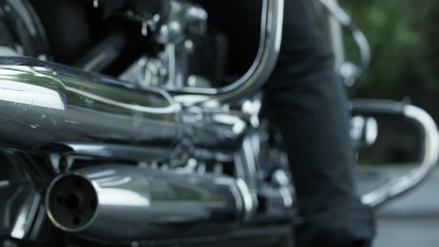 Biker getting off his motorcycle. Shot on RED EPIC Cinema Camera in slow motion .