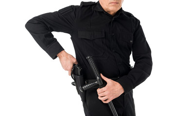 Close-up view of policeman in uniform pulling out gun isolated on white