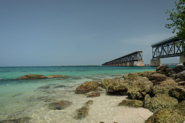 Clear and warm beaches of the Florida Keys with the historic Flagler built railroad bridge in the background