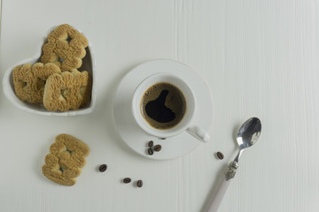 a cup of coffee with biscuits