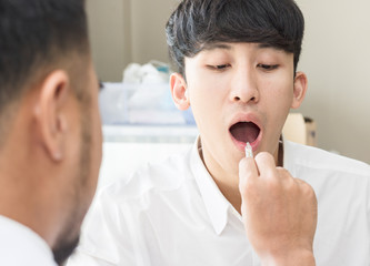 The doctor is diagnosing man patient's symptoms.