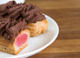 delicious eclairs with fruit filling on a plate