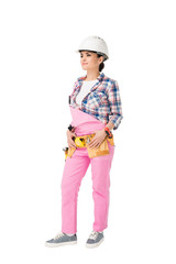 Attractive female builder in pink uniform with tool belt isolated on white