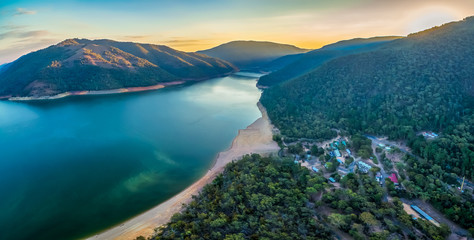Aerial panoramic view of lake Burrinjuck and forested hills at sunset in Australia