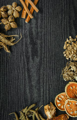 Dried herbs and Ginseng, Top view of Thai herbs and ginseng on wooden floor. Slices of dries root for make a herb juice on the dark table.