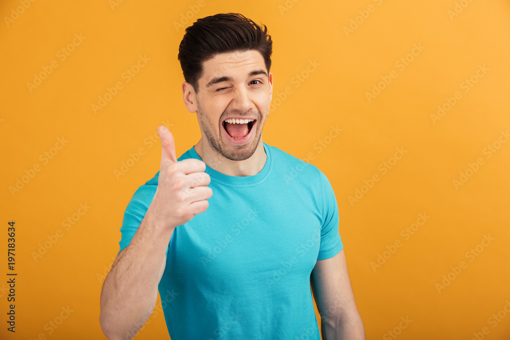 Canvas Prints Portrait of a cheerful young man in t-shirt