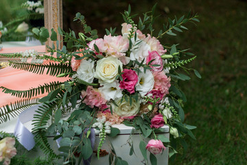 A wedding bouquet lies on a dressing table