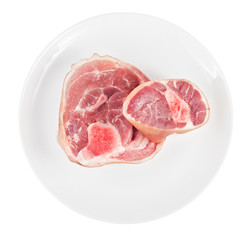 Raw pork knuckle on plate isolated on white