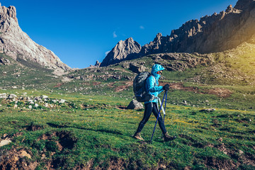 Fototapeta premium backpacking woman hiker walking on beautiful mountains