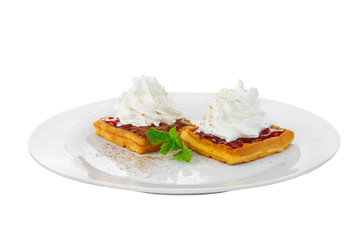 Thick wafers with berry red jam and whipped cream top with a sheet of mint on a plate on a white isolated background. Dessert for a menu in a cafe, restaurant, coffee shop side view