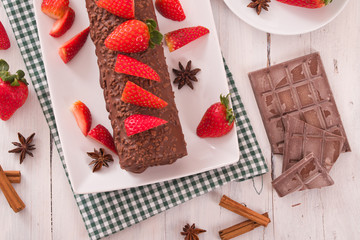 Chocolate roll with strawberries. 