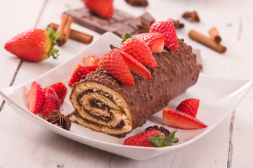 Chocolate roll with strawberries. 