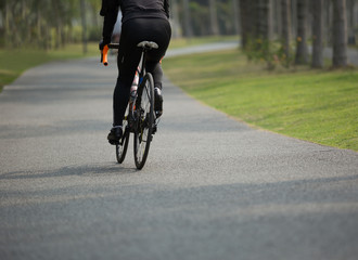 Fototapeta na wymiar woman cyclist riding bike on forest trail