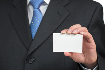 Man's hand showing business card - closeup shot on white background