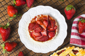 The strawberry pie in the wooden background