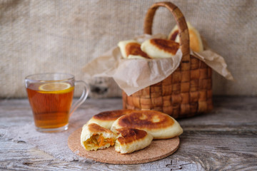 homemade cabbage pies on the table and lemon tea