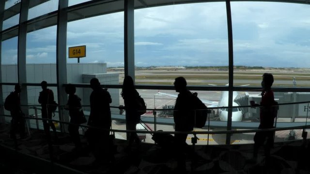 Passengers Walking In Airport Terminal After Aircraft Landing