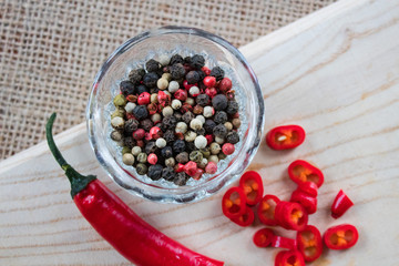 Chili pepper lies on a sackcloth on a wooden table.