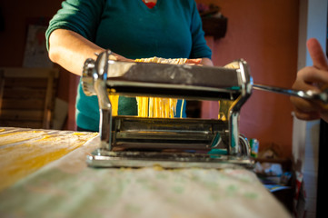 preparation of fresh pasta homemade tagliatelle with the machine by hand