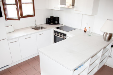 Modern white kitchen in a beautiful  house