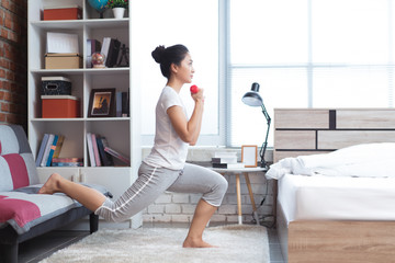 Asian women exercising in bed in the morning, she feels refreshed.She acts as squat.