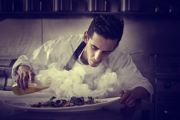 Chef preparing octopus in kitchen with smoke