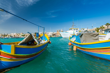 Fototapeta na wymiar Beautiful colorful fishing boats in Marsaxlokk harbour,Malta