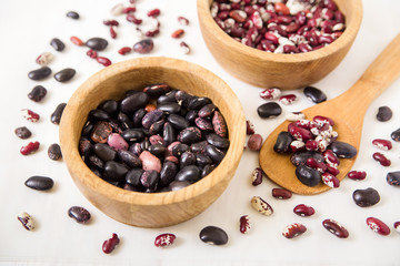 red and black kidney beans.wooden plates and spoon.close-up view