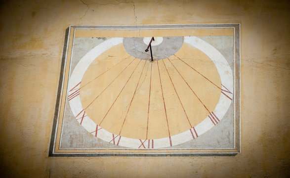 Sun clock on a wall of the City hall in the medieval town Entrevaux (Alpes de Haute Provence, France). Vignette.