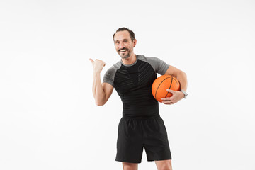 Portrait of a smiling mature sportsman holding basketball