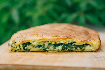 Cake with spinach egg and cheese. Tasty pie