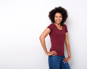 happy young african woman standing against white background