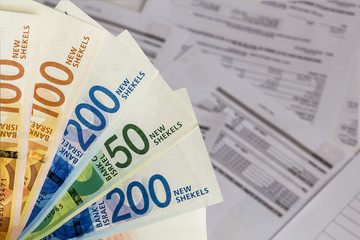 Israeli New Shekel banknotes on the Bills background.Concept of Business,banking and pension...