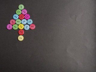 Colorful bottons with tree shape on black background