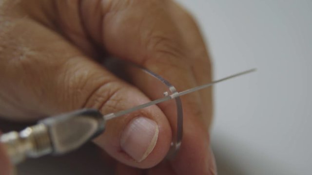 The process of manufacturing eyeglasses, boring holes