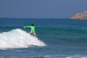 Young boy surfing on ocean waves
