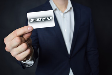Businessman shows business card with the inscription:INDUSTRY 4.0