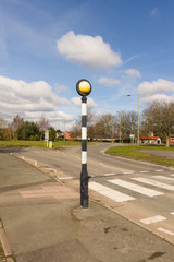 British Belisha beacon an amber flashing light on a black and white pole marking pedestrian crossings in the United Kingdom © David Pimborough