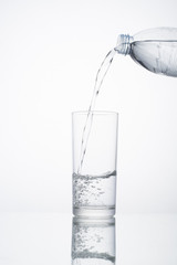 Pour clean drinking water into a glass of water.