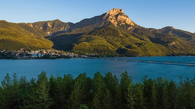 Timelapse of Savines-le-Lac, Grand Morgon Peak and the Serre-Poncon Lake from sunset to twilight. Hautes-Alpes, Southern french Alps, France