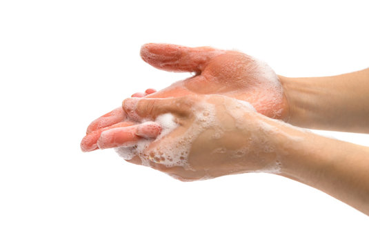 young female washing hands with soapy liquid on white