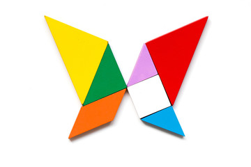 Color wood tangram puzzle in butterfly shape on white background