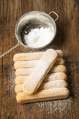 sponge biscuit - ladyfinger savoiardi on a wooden table