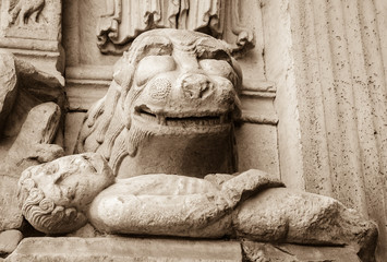 Lion devouring the sinner. Architectural detail. Facade of the church of St. Trophime in Arles,...