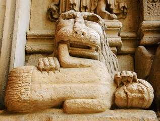 Lion devouring the sinner. Architectural detail. Facade of the church of St. Trophime in Arles,...
