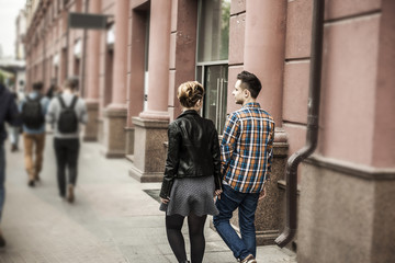 modern loving couple on a walk through the streets of the city