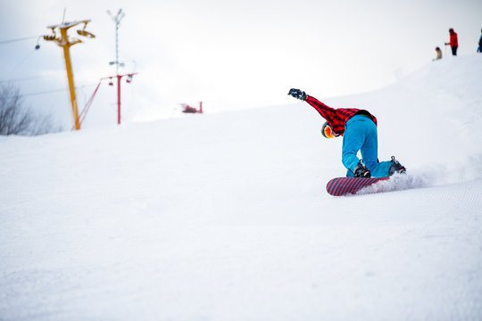 Picture of athlete with snowboard jumping on snowy hill