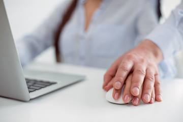 Harassment victim. Close up of a male hand being put on the female hand while harassing her