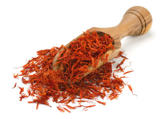 Saffron herbs in wooden scoop