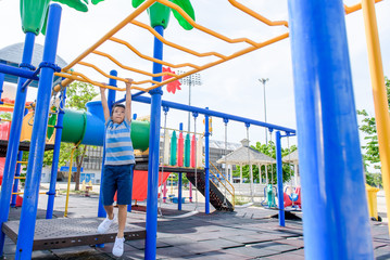 Young asian boy hang  out door playground